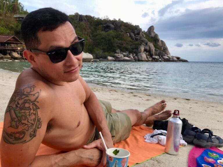 Man on beach looking into camera